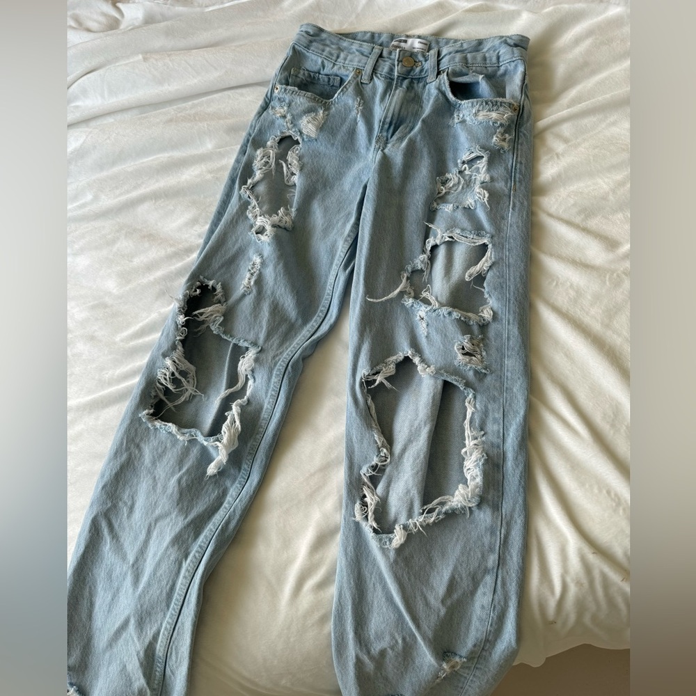 light-wash distressed jeans with an ultra-ripped design.
